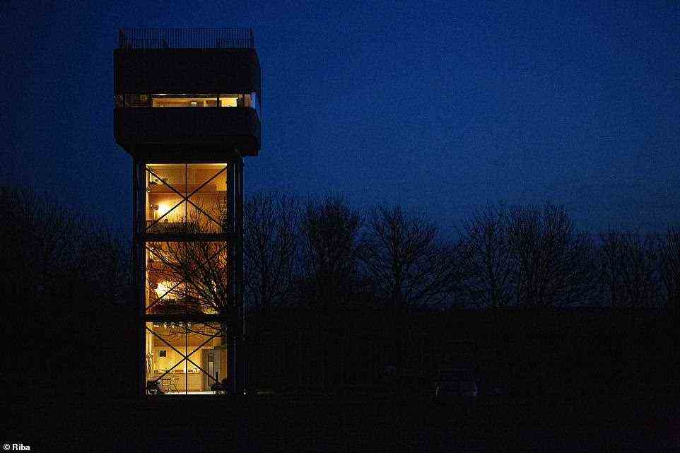 At night lights within the water tower reveal a bright and comfortable interior, with plenty of space to live
