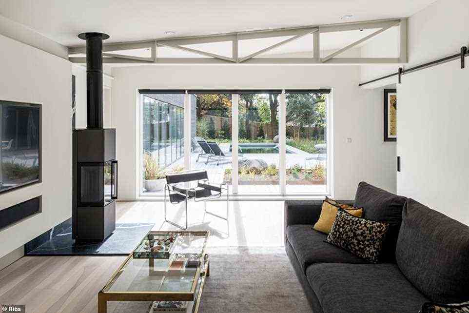 The living room of Hove House allows its occupants plenty of light through large sliding doors which offer and inside outside feel to the space