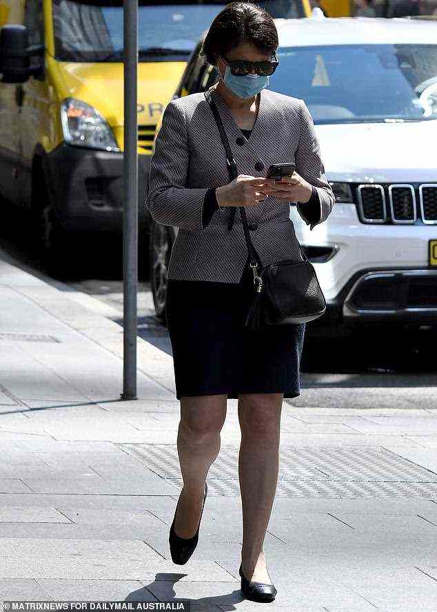 Gladys Berejiklian (pictured) checks her phone while out for a walk in Sydney