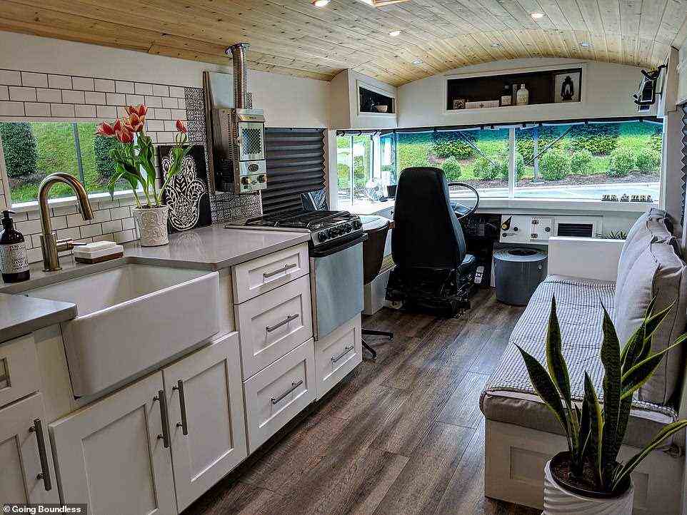Designed to look like a 'tiny house', Robbie and Priscilla's converted school bus, pictured, has a wood-burning stove and quartz countertops