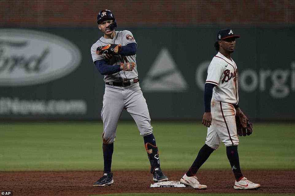 Houston Astros' Carlos Correa celebrates after an RBI-double during the third inning on Sunday night in Atlanta