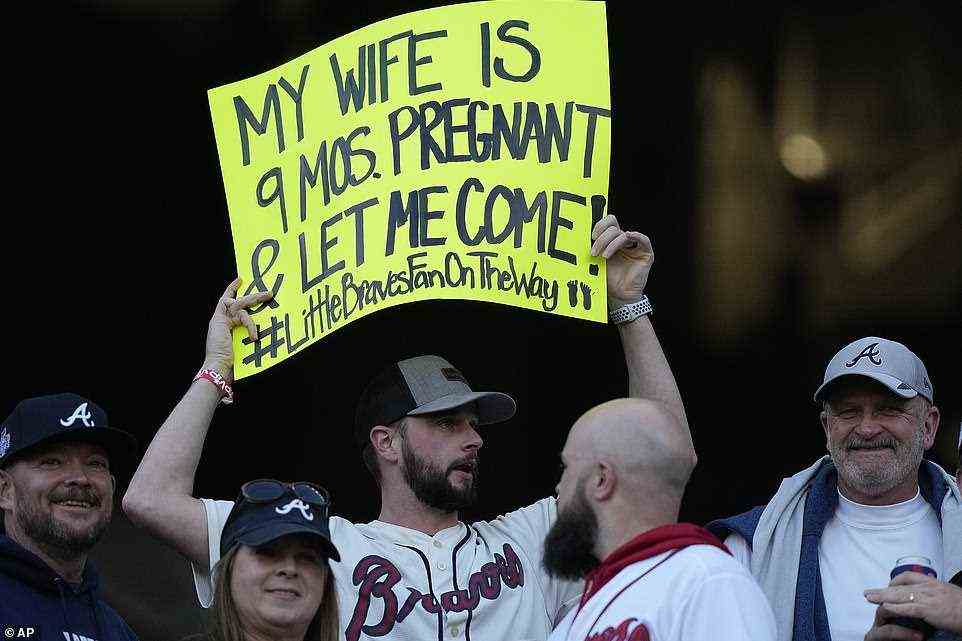 A Atlanta Braves fan holds up a sign during batting practice before Game 5 of the World Series against the Houston Astros