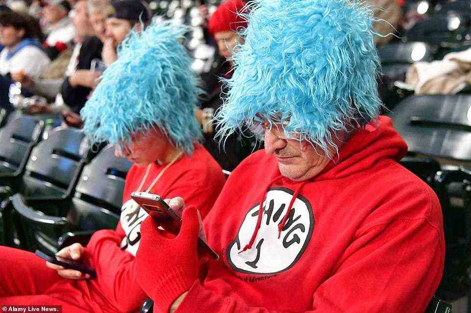 Doug (R) with daughter Sydney of Atlanta and dressed as Thing 1 and Thing 2 for Halloween during Sunday's Game 5