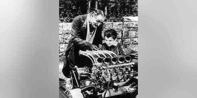 Al Lewis und Butch Patrick arbeiten zusammen an einem Motor in einer Szene aus der Fernsehserie 