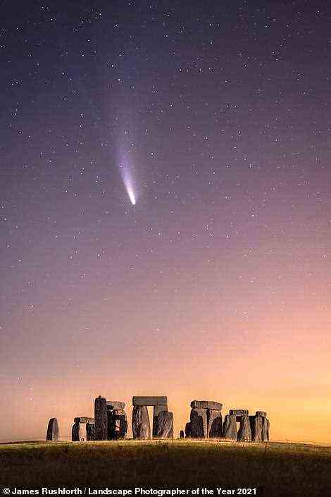 Runner-up in the Historic Britain category in this priceless shot by James Rushforth of comet Neowise passing over Wiltshire's Stonehenge. He says: 'It's fascinating to think that this historic site did not exist when Neowise last passed the Earth. The comet is due to return in approximately 6,800 years. I wonder if the stones will still be standing? This is a single-exposure photograph taken early on the morning of July 20. The orange glow is light pollution from the nearby villages of Durrington and Larkhill, and a passing lorry very kindly painted the rocks with light'