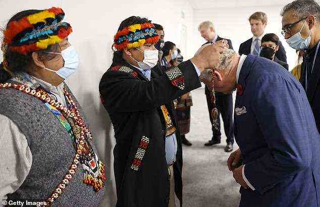 The royal could be seen bowing his head as he was given the necklace by Juan Carlos Jintiach, coordinator of international economic cooperation and autonomous indigenous development of the Amazon Basin