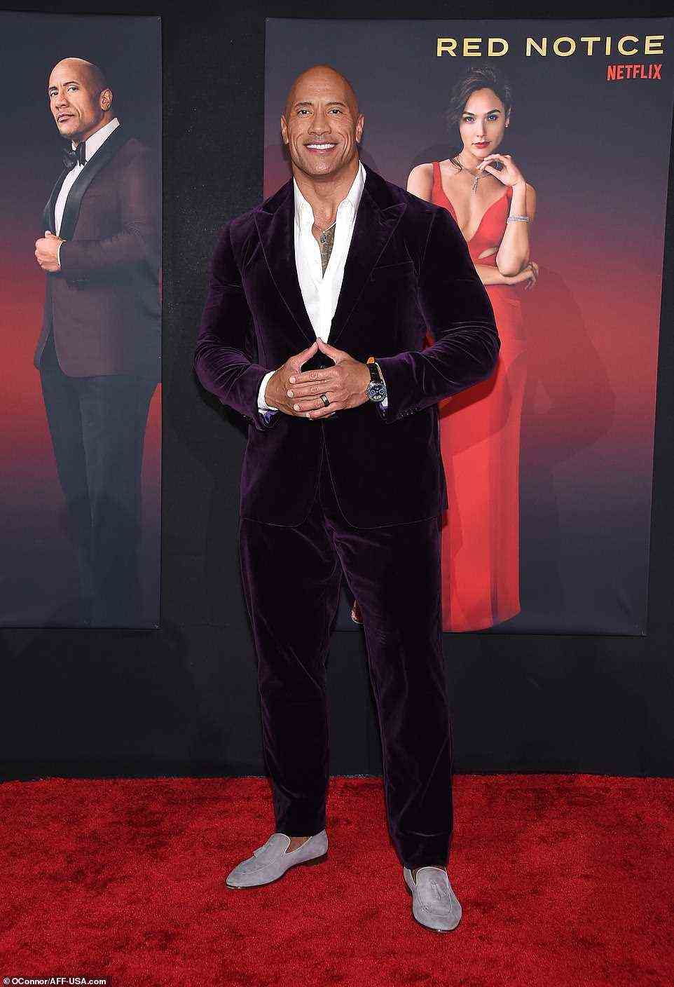 Too cool: Dwayne looked effortlessly cool in a plum velvet suit, which he styled with an unbuttoned white dress shirt and a pair of loafers