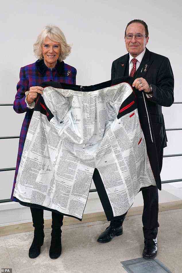 The Duchess of Cornwall with Peter James, holding one of his coats with one of his book scripts printed on the inner lining