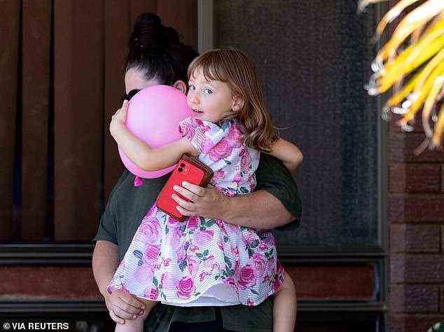 Clutching a pink balloon, Cleo Smith was pictured in her mum's arms outside her Carnarvon home on Thursday, 24 hours after her incredible rescue