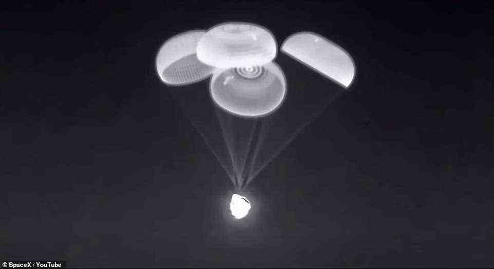 Four parachutes opened as the capsule returned to Earth, granting a soft landing in a calm sea