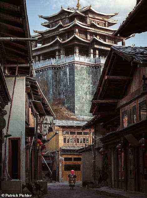 A street in the lofty Himalayan city of Shangri-La, formerly known as Zhongdian, in Yunnan Province. In the 1933 novel Lost Horizon, English author James Hilton described the supposedly fictional city of Shangri-La as existing in a place where people 'live to be hundreds of years old'. Far Far East reads: 'Before his death, he claimed that the mysterious place surrounding the enigmatic city really existed.' In 2001, after years of speculation, Zhongdian was renamed Shangri-La to boost the regional economy. Schels and Pichler write: 'The mystical Shangri-La became the Chinese El Dorado - the golden city that would hopefully fill the coffers of the province. Is it really the city described in Hilton's book?'