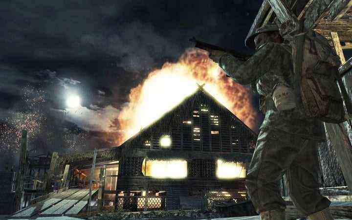 Soldier next to burning house in Call of Duty: World at War.