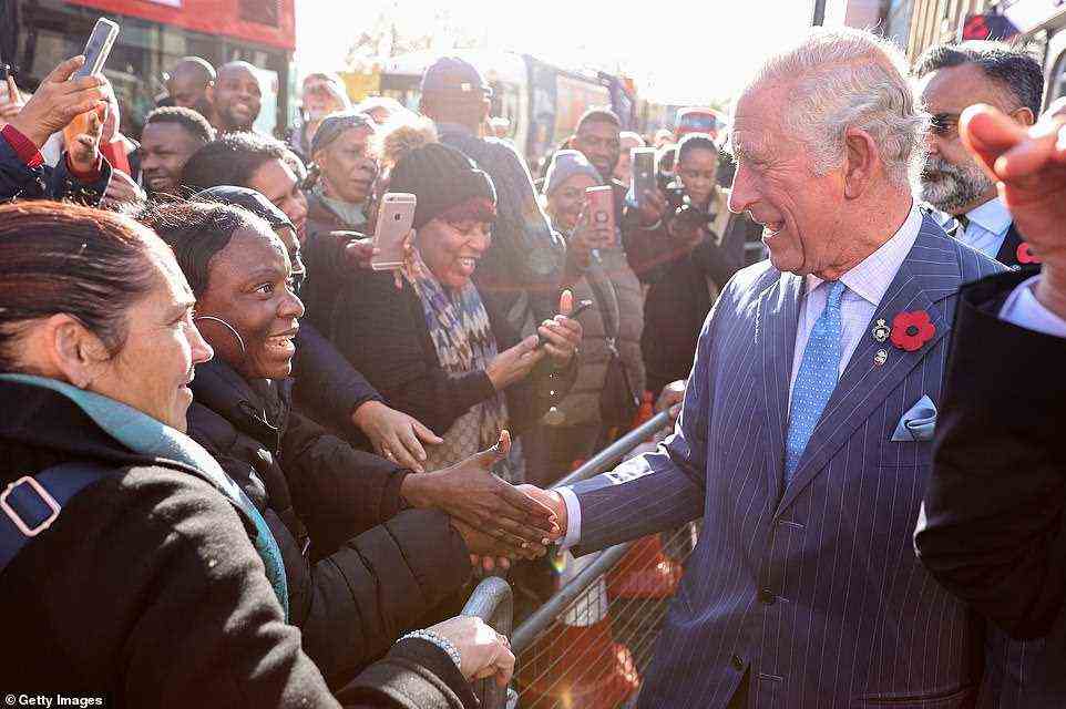 The 72-year-old Prince of Wales is given a very warm welcome by people gathered on a street in Brixton this morning
