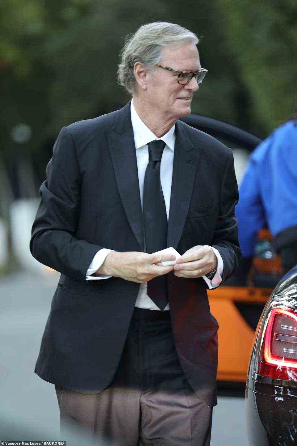 Classic: Paris' father Rick Hilton, 66, cut a classic figure in a solid black suit paired with white dress shirt and a black tie