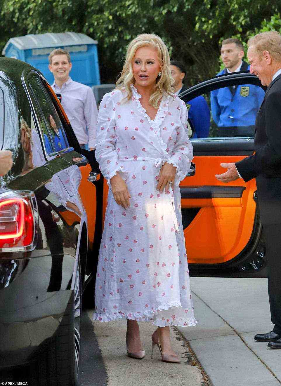 Love on the brain: Paris' mother Kathy Hilton stunned in a white heart-patterned wrap dress and a pair of blush toned heels as she was captured arriving to the Bel-Air estate ahead of Carter and Paris' nuptials
