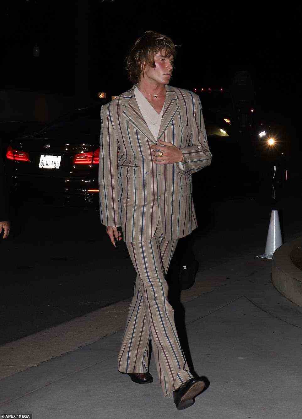Runway-ready: Jordan Barrett looked fresh off the runway in a stylish pinstripe suit and brown designer loafers