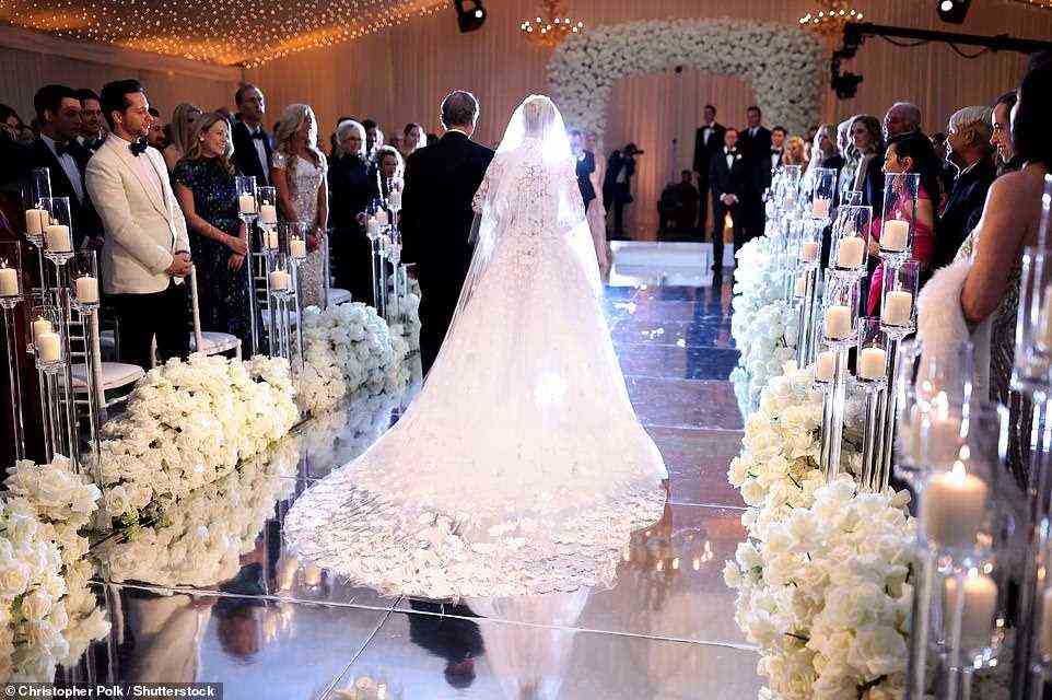Electrifying: Paris walked down a mirrored aisle with her father at the spectacular event