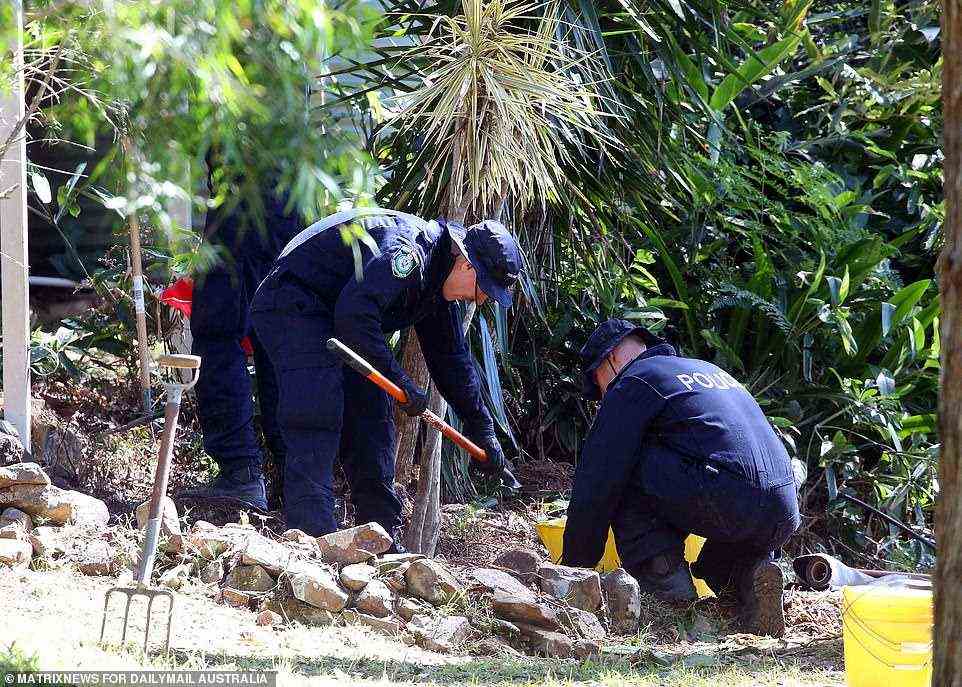 Police are seen examining garden beds at the property where three-year-old William Tyrell went missing