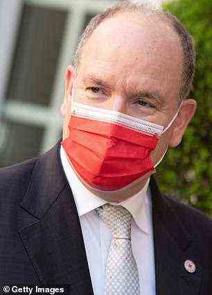 The royal opted for a red face covering as he visited the organisation in Monaco earlier today on a solo engagement