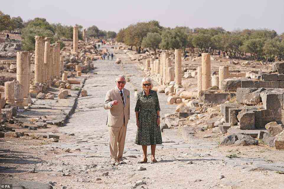 Looking dapper! Charles opted for a camel-hued suit while Camilla wore a sage-coloured ditzy floral dress - with both choosing comfortable shoes for the early morning walking tour