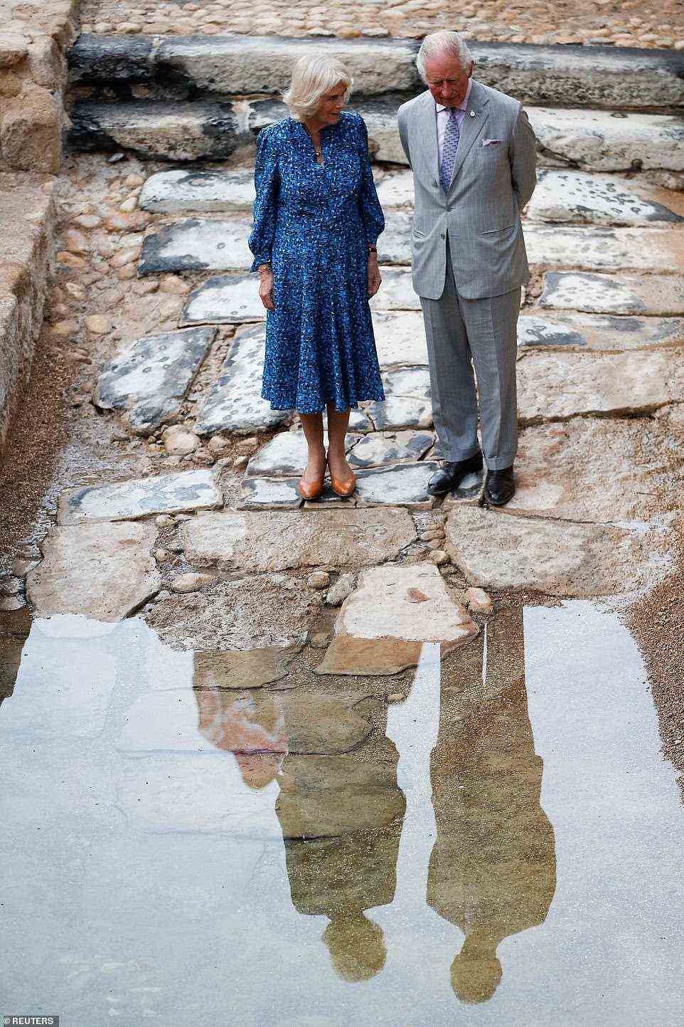 Let's take some home! The Prince of Wales and the Duchess of Cornwall dipped their fingers in water from the holy River Jordan which is used to baptise royal babies - with Charles rumoured to have requested bottles of the water to take home for future royal baptisms