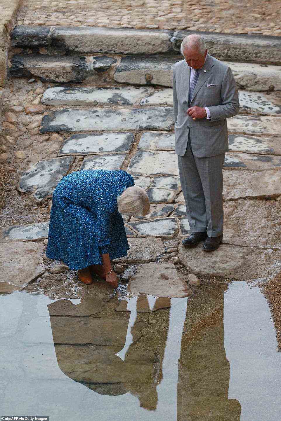 The Duchess of Cornwall was seen bending down and dipping her fingers in water from the holy River Jordan which is used to baptise royal babies