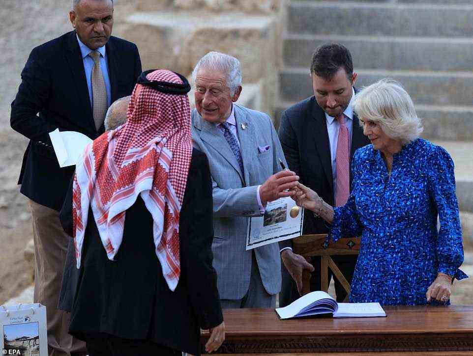 Prince Charles signed the guest book as he and Camilla visited the baptism site of al-Maghtas