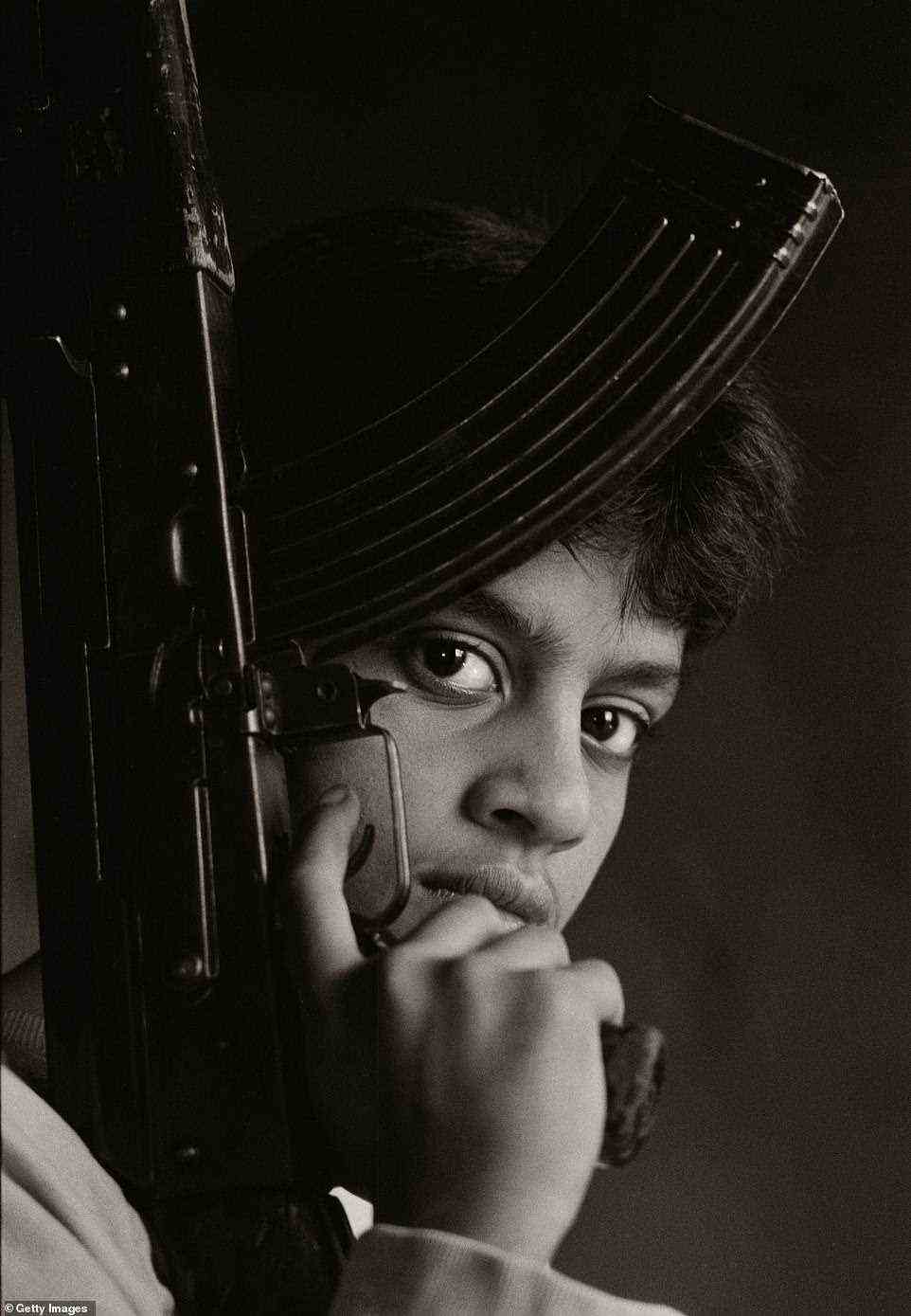 Stoddart took this piercing image as a Palestinian boy fighter poses with his AK-47 in Chatilla refugee camp in Beirut, 1987