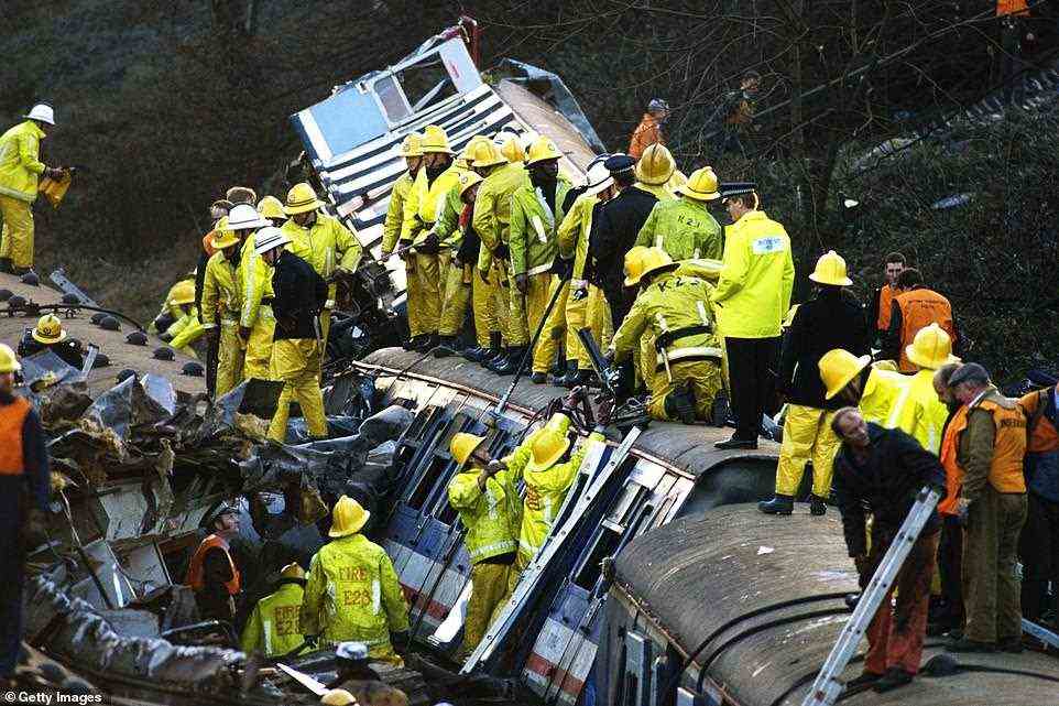 Fire crews and policemen work to free the dead and rescue the injured from derailed carriages after a rail crash near Clapham Junction in London, which saw 35 people killed and over 100 people injured, pictured by Tom Stoddart in December 1988