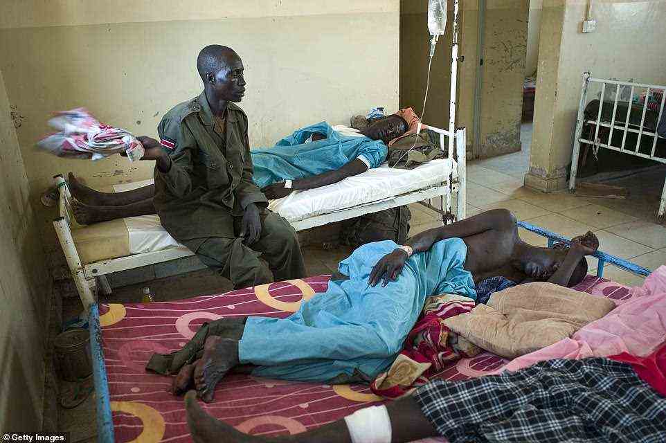 Stoddart was in Sudan in 2012 when fighting was taking place between the Sudanese People's Liberation Army and government troops. Pictured: SPLA soldiers lie wounded in a Bentiu men's hospital ward  in Unity State, South Sudan