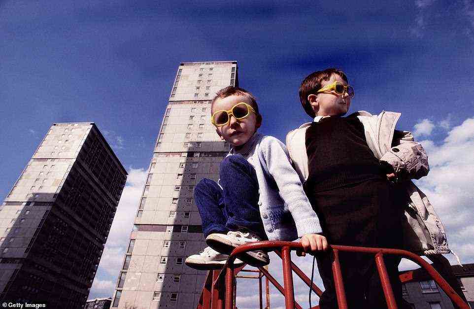 Another of Stoppard's pictures shows  children wearing yellow sunglasses playing outside their apartment block homes on a Glasgow estate in March 1990