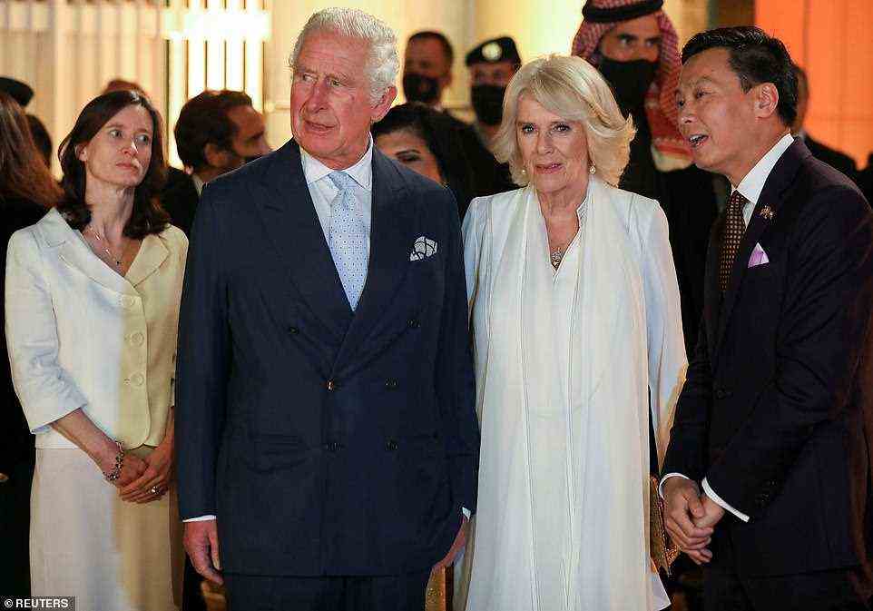 Bridget Brind, dressed in white, left, listened on as Prince Charles and the Duchess of Cornwall spoke with British Council Director in Jordan Summer Xia, right