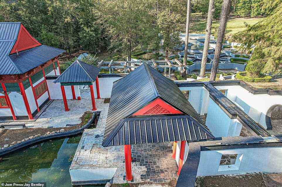Care for a stroll? Photos show the red and black structures and koi ponds on the property