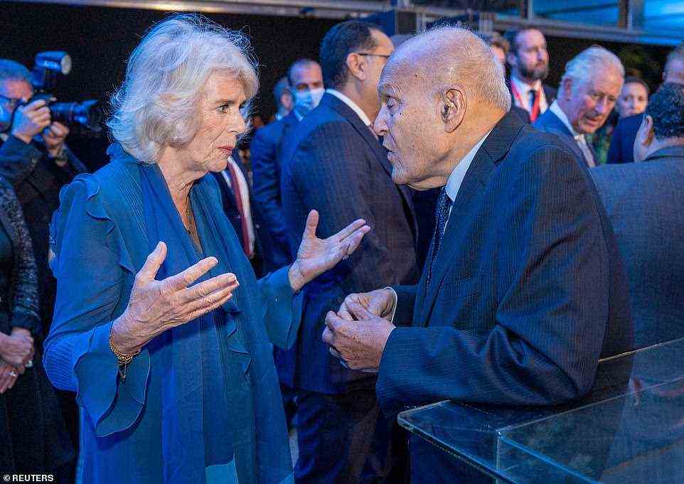 The Duchess of Cornwall looked stylish in a frilly navy blouse as she chatted with retired surgeon Magdi Yacoub at tonight's event