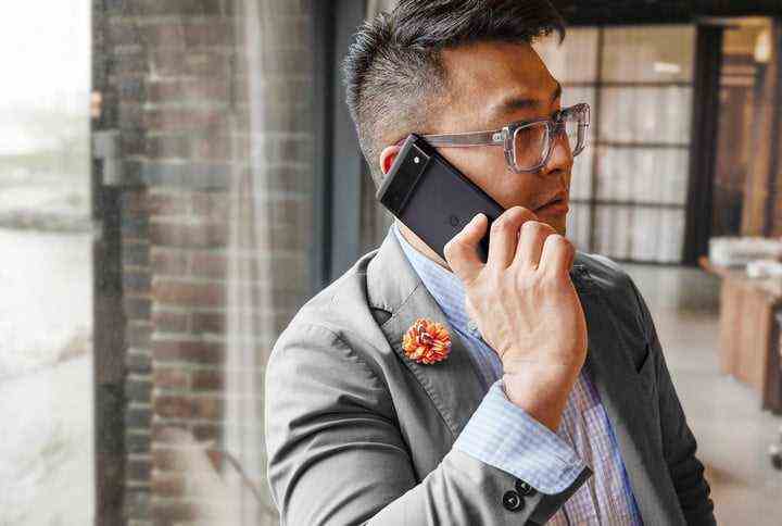 A man talking on the phone using the Google Pixel 6p smartphone.