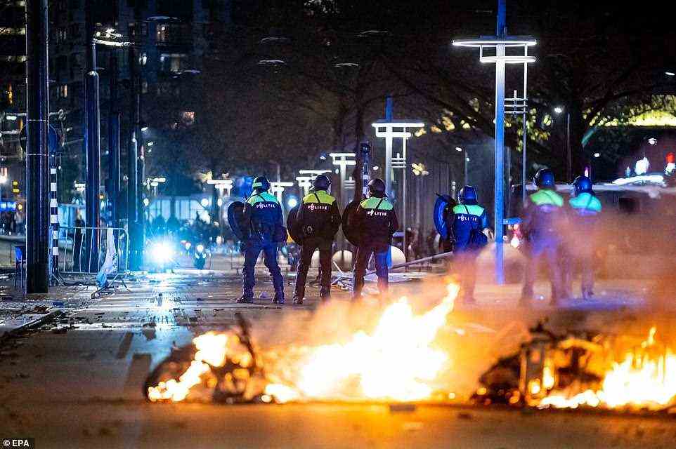 At least one person was shot and six more injured in Rotterdam last night as Dutch riot police opened fire on protesters