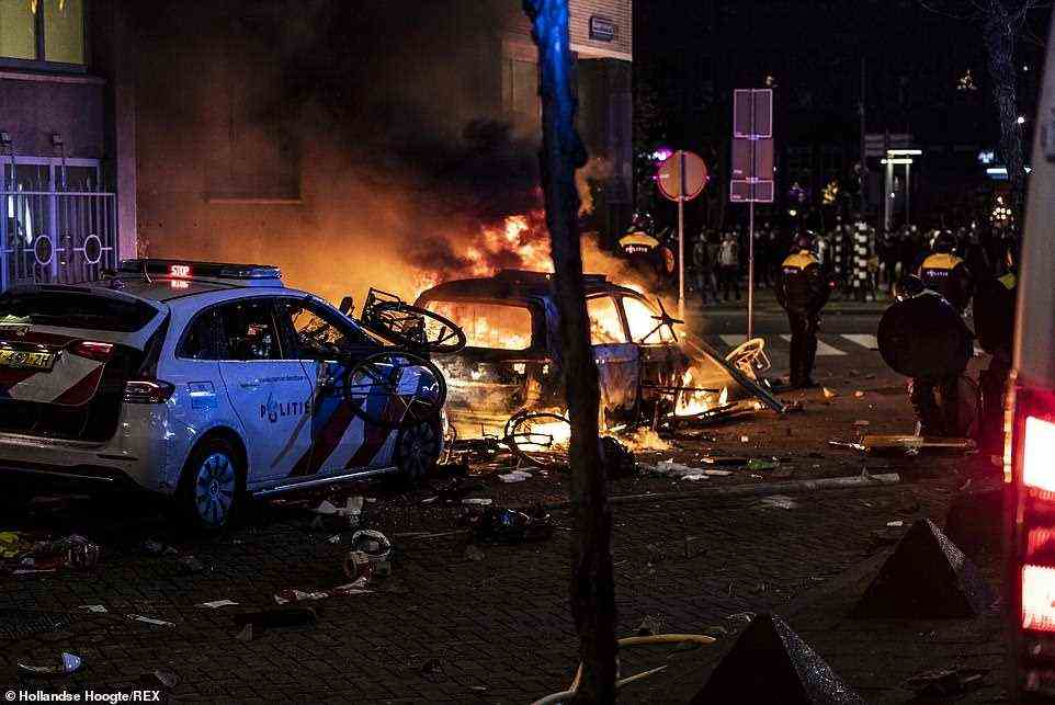 Rioters set vehicles ablaze as anti-lockdown protests turned to riots in Coolsingel street, Rotterdam, on Friday evening