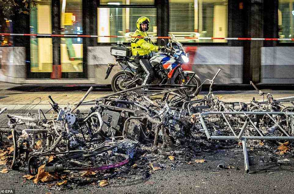 Piles of burned bikes lay strewn across the streets of Rotterdam on Saturday morning following anti-lockdown protests after the government announced its 2G policy, restricted unvaccinated people's access to certain venues