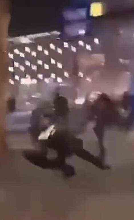 Pictured: A grab from video showing a police officer in Rotterdam being kicked over on Friday night