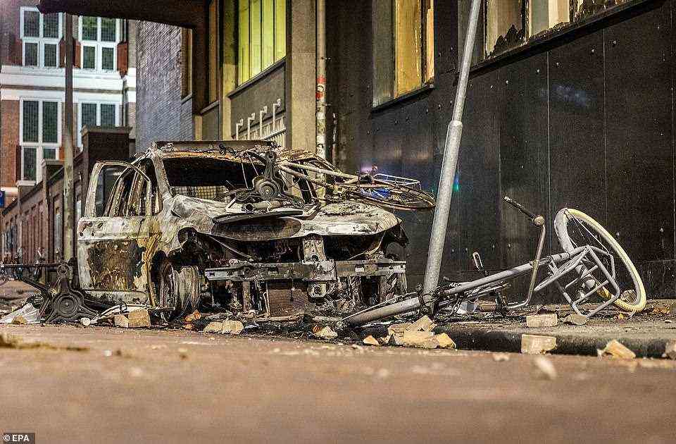 Carnage lined streets of Rotterdam on Saturday morning after a night of violent demonstrations in which one person was shot