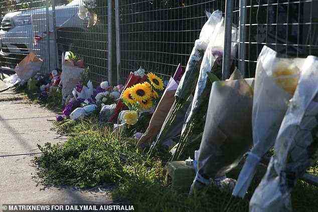 A shrine of floral tributes continues to grow outside the home where four siblings between the ages of 10 and one died early Sunday