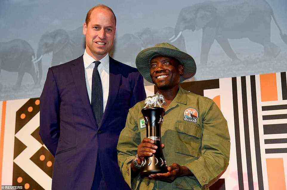 Tusk Wildlife Ranger Award winner Suleiman Saidu holds his trophy next to the Duke of Cambridge at the Tusk Conservation Awards in London