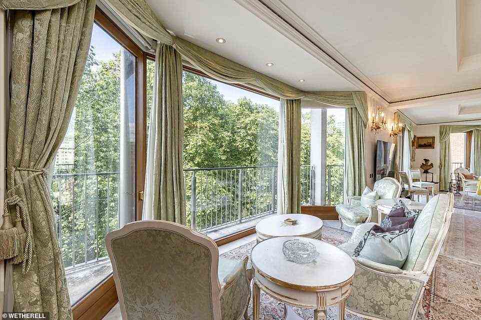 The centrepiece of the apartment is a 44ft dual aspect reception room with coffered ceiling and marble flooring, incorporating full height glazing overlooking Hyde Park including two bays with floor-to-ceiling windows and ornamental balconies