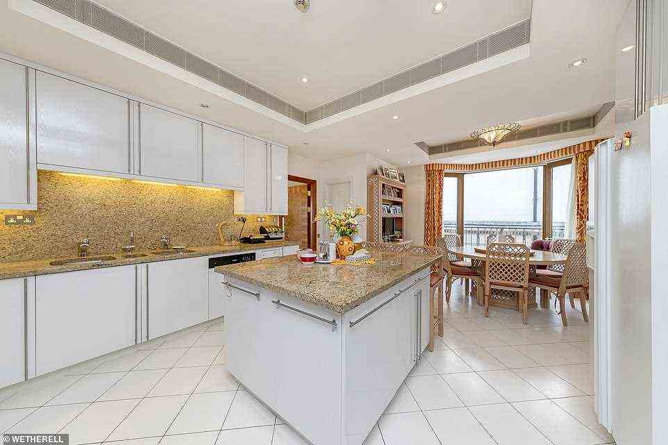 The spacious family kitchen has a central island, breakfast/dining area and a separate utility room while boasting panoramic views over central London