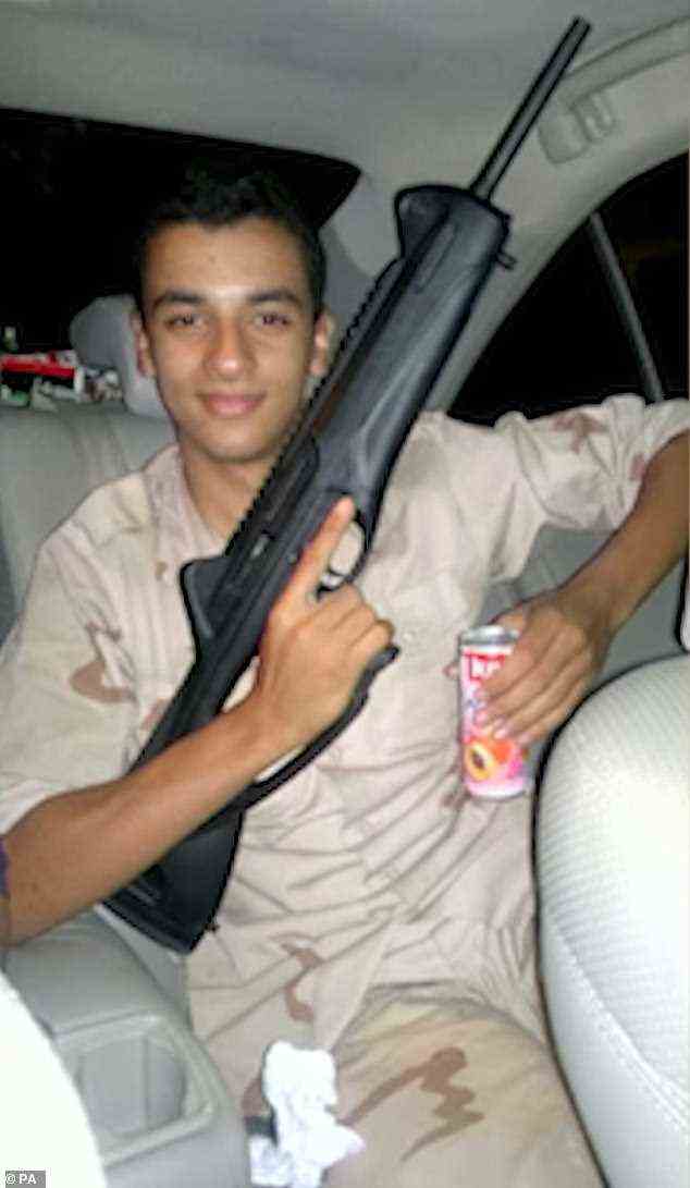 Ismali Abedi, brother of Manchester bomber Salman Abedi, pictured posing with machine gun while sporting camouflage wear and drinking a soft drink in the back of a car