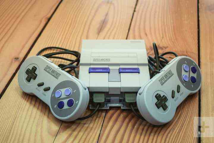 The SNES Classic Edition and both of its controllers against the corners.