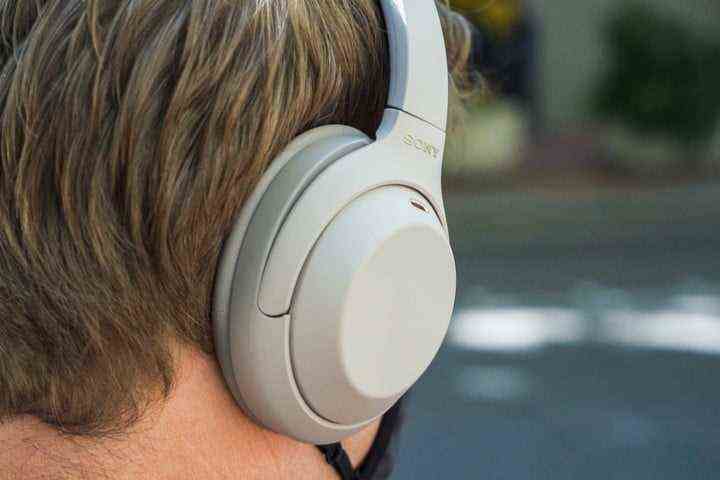 A person wearing the Sony WH-1000XM4 headphones.
