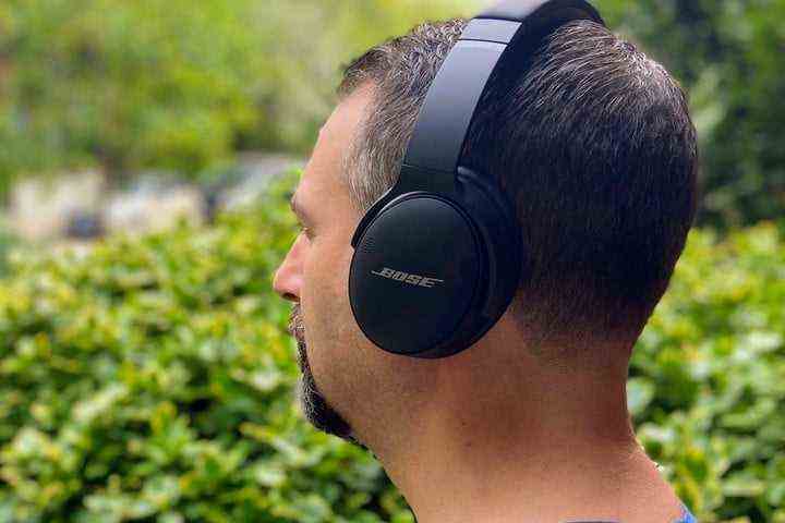Man wearing Bose QuietComfort 45 noise-canceling headphones.