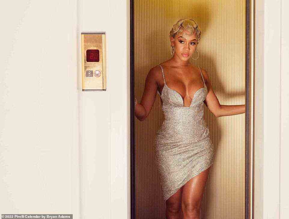 Vintage glamour: Rapper Saweetie, 28, slipped into a plunging silver dress paired with blonde curls for her shot