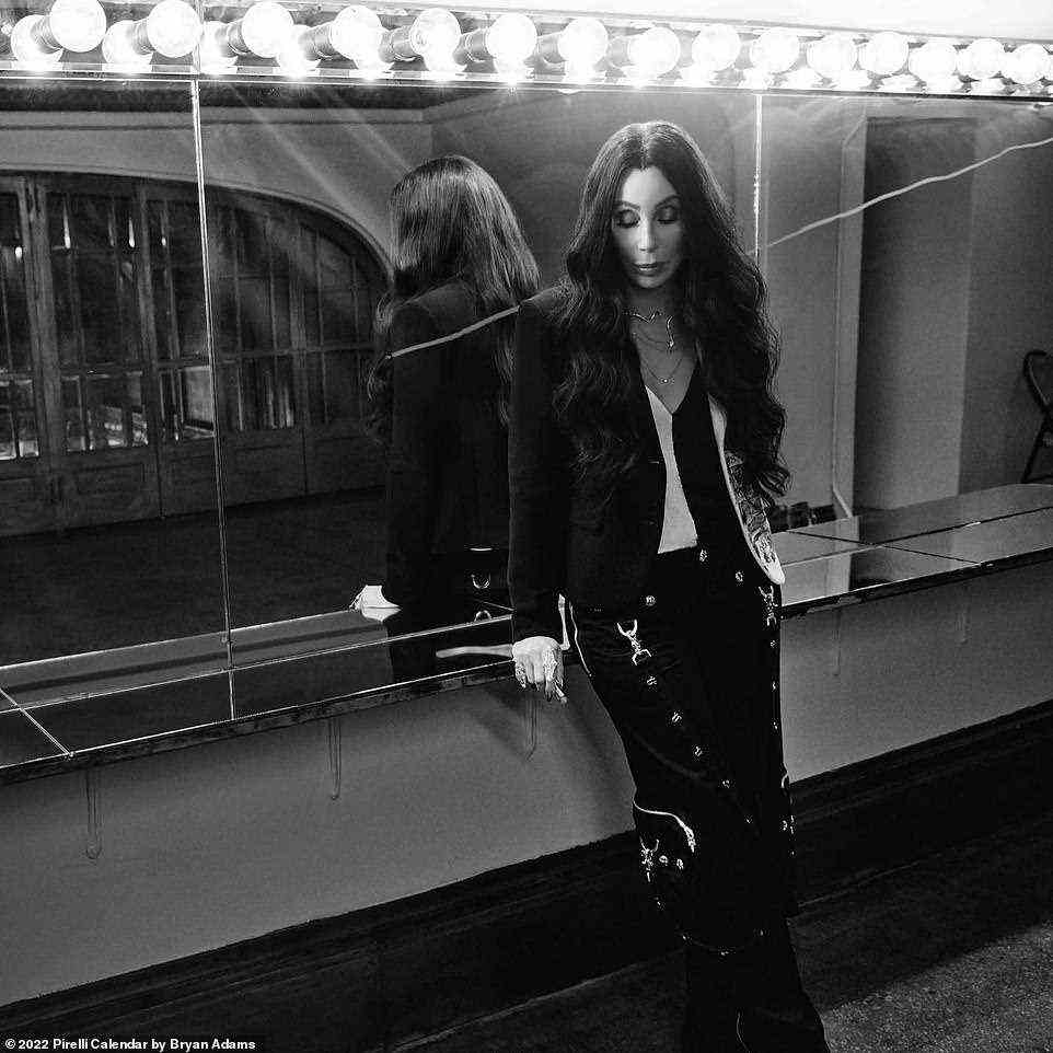 Timeless: Music icon Cher, 75, brought her timeless glamour as she relaxed backstage before her show, clad in a black and white blouse, chain adorned trousers and a black blazer